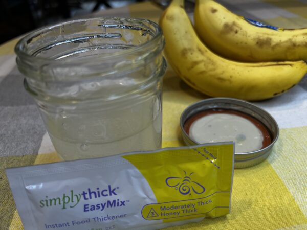 beginner recipe of making slurry, jelly jar half full thickened water, packet of simply thick food thickener , bunch of bananas