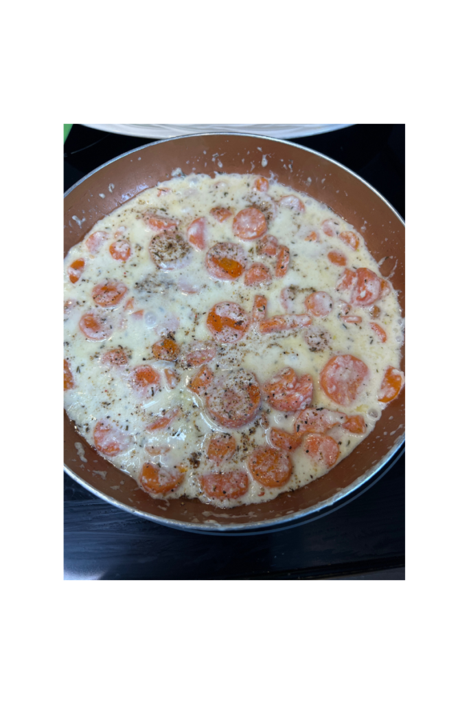 frying pan of carrots simmering in a white cream sauce