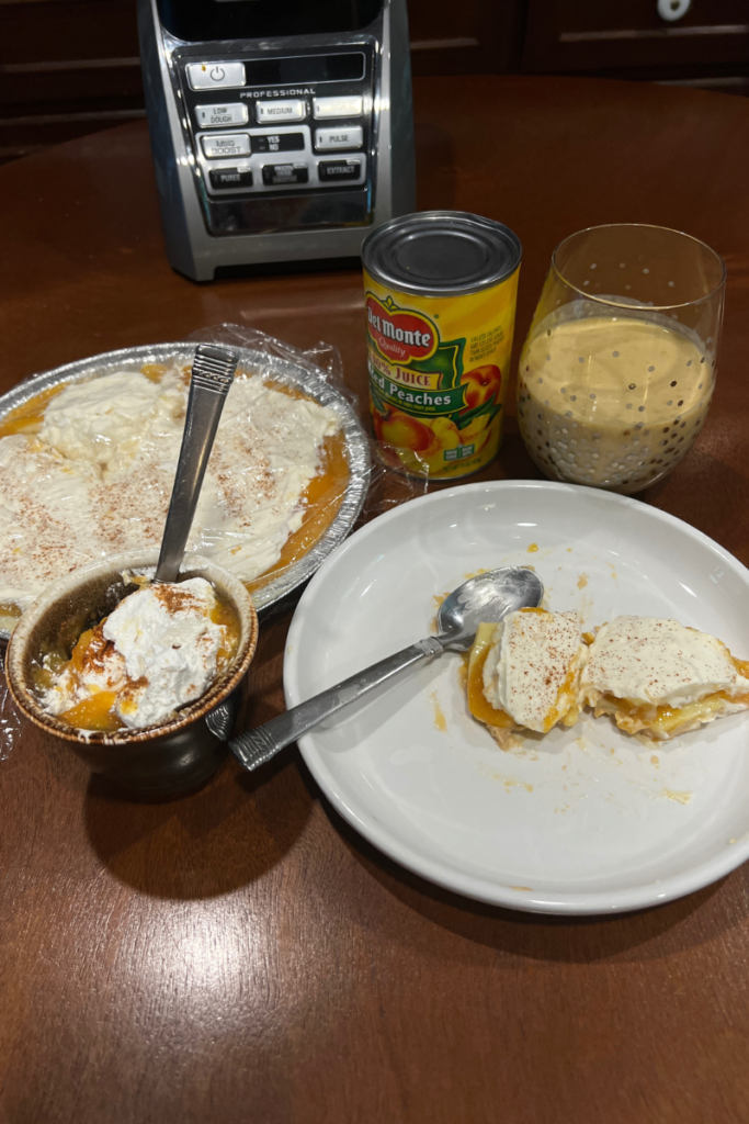 grouping on a table of peach cream pie, bowl of peaches and cream, saucer of slice of peach cream pie, glass of peach smoothie and can of peaches